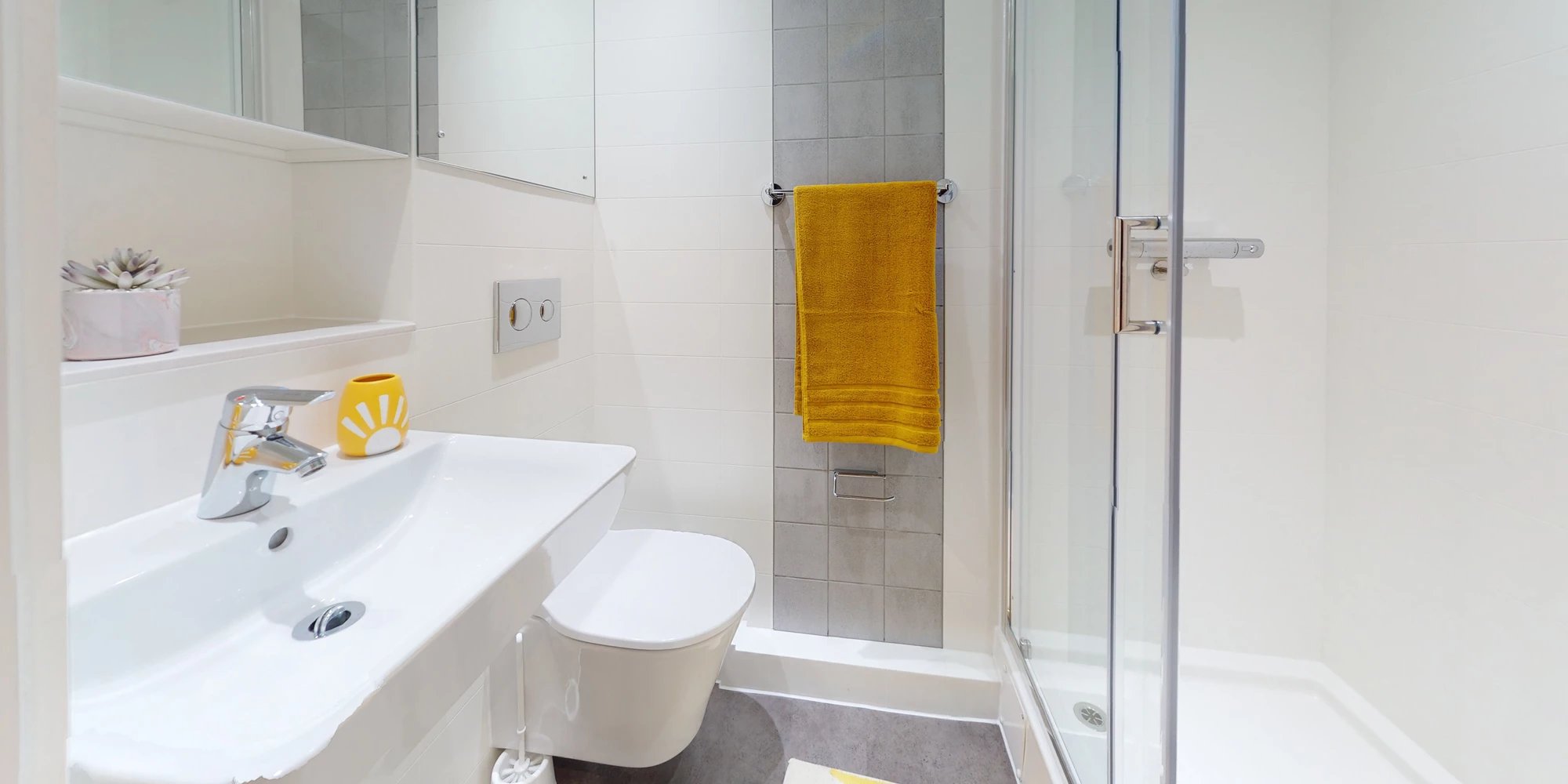 Sink toilet shower yellow towel bathroom at Canvas Coventry City Point in Coventry Student Accommodation