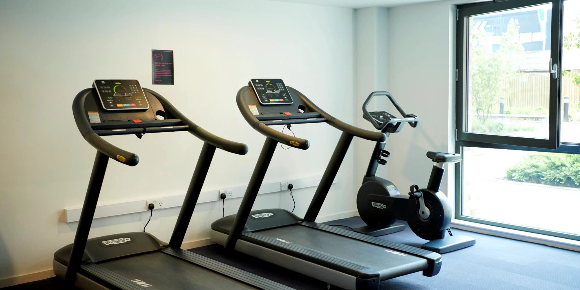 Two treadmills and exercise bike playing area at Canvas Glasgow in Glasgow Student Accommodation