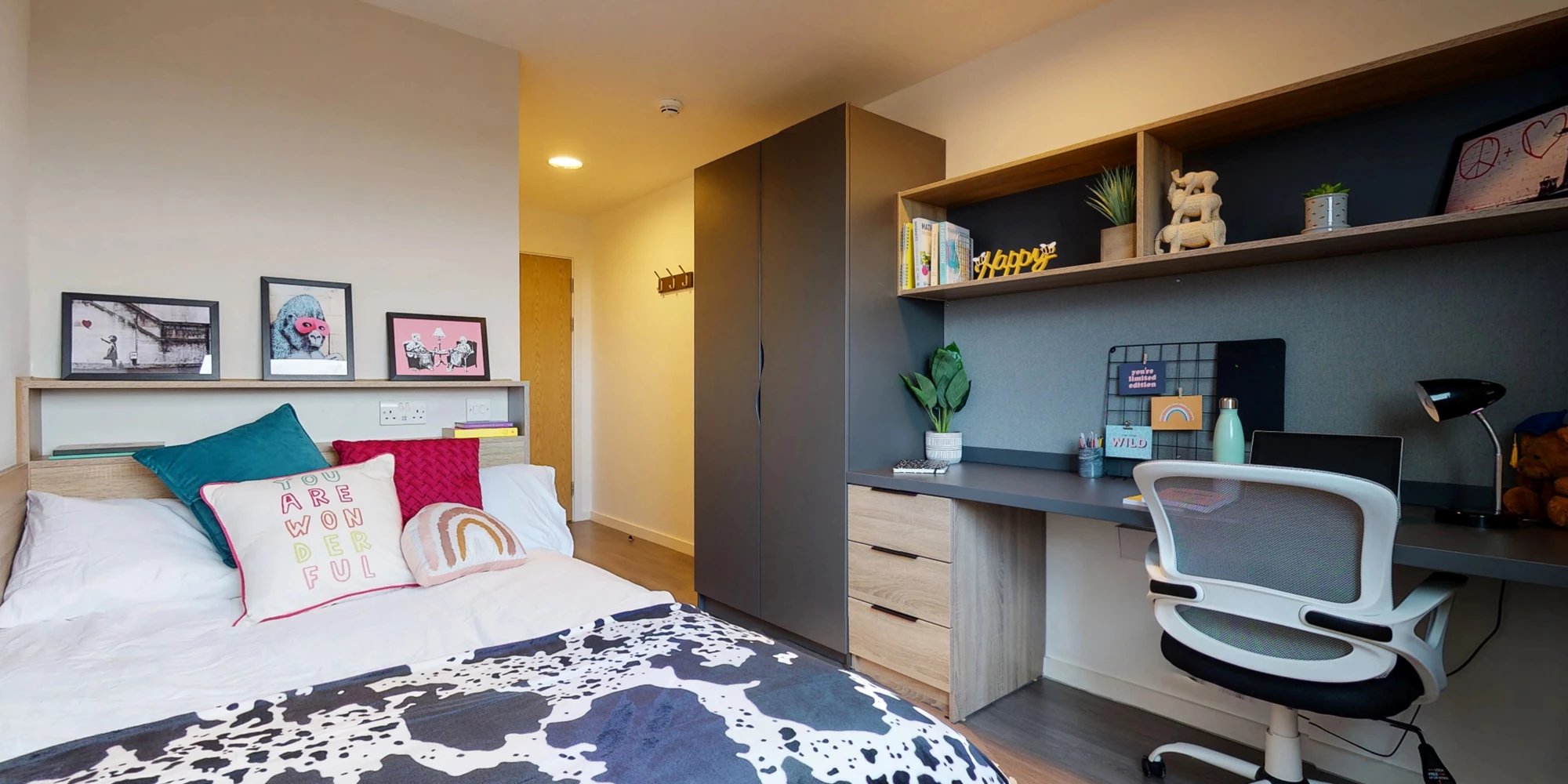 Bed desk wardrobe framed art and chair bedroom at Canvas Glasgow in Glasgow Student Accommodation