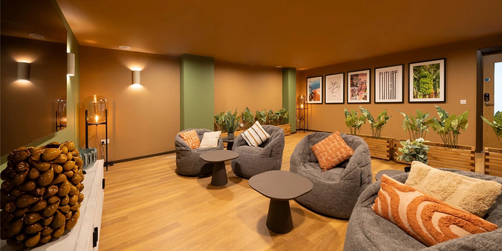 Beanbags tables plants art on wall lounge at Canvas Glasgow in Glasgow Student Accommodation