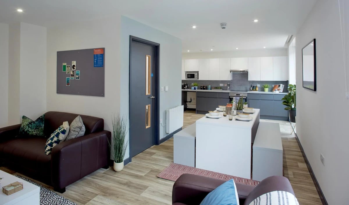 Sofa dining table kitchen and seating area living room at Eden Square in Coventry Student Accommodation