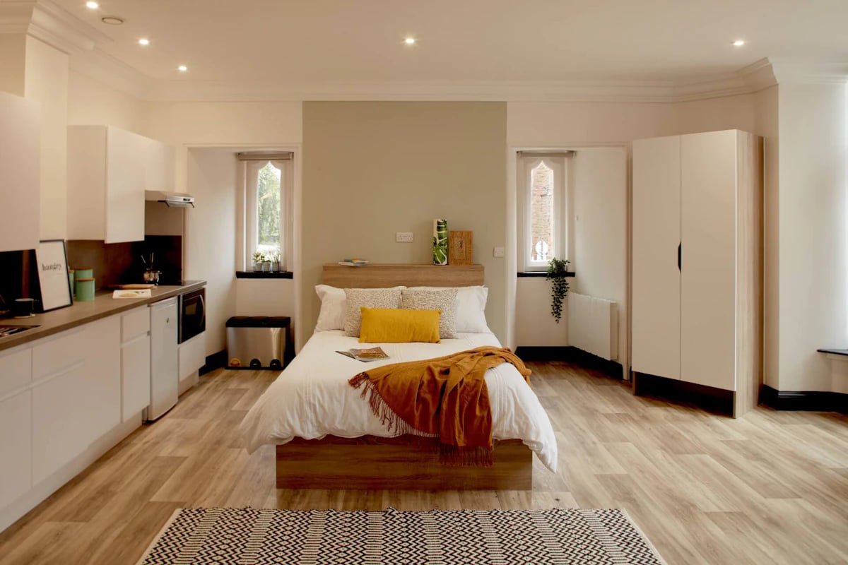 Bed kitchen wardrobe and windows student studio apartment at Eden Square in Coventry Student Accommodation