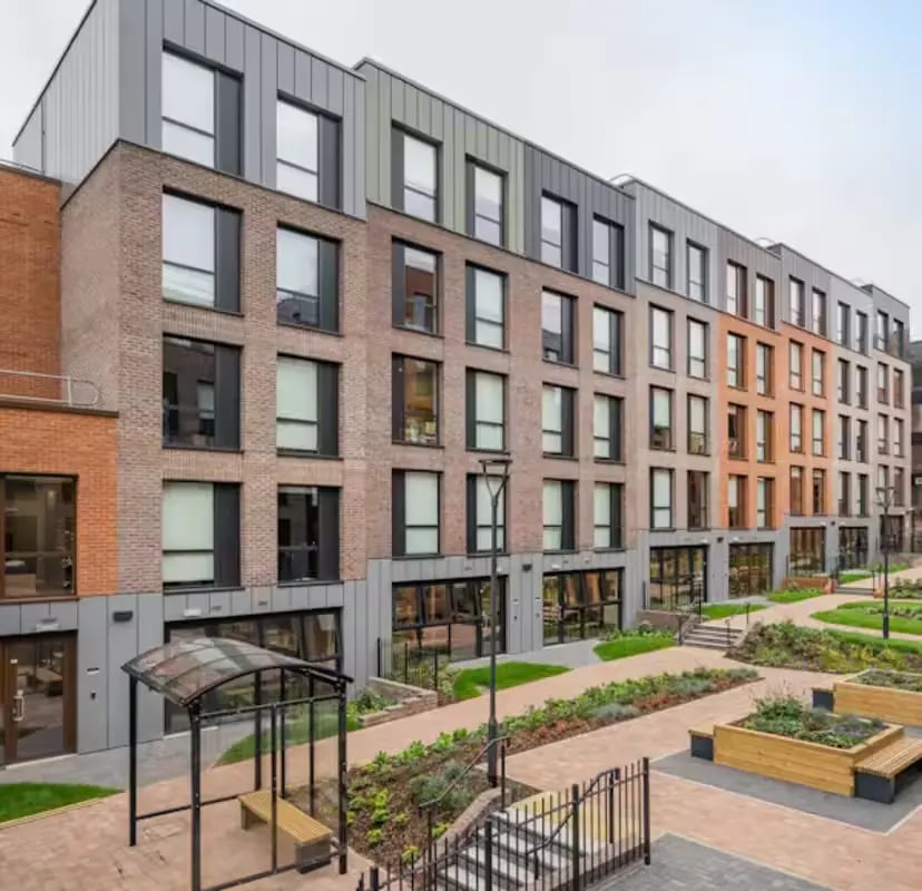 Brick building with modern windows and benches exterior at Zinc Quarter in Bristol Student Accommodation