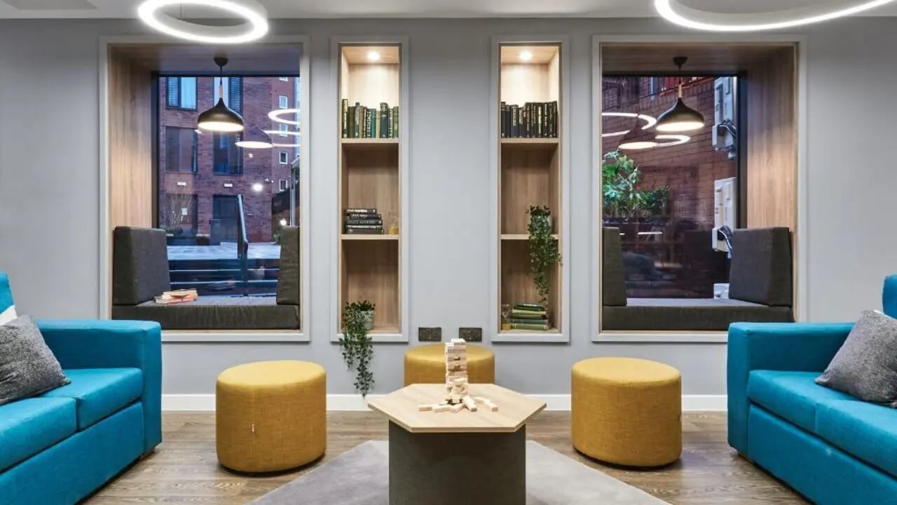 Two blue sofas Jenga table and stools common area at 41 Castle Street in Leicester Student Accommodation