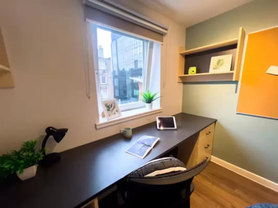 Desk with lamp tablet and chair study area at Portsburgh Court in Edinburgh Student Accommodation