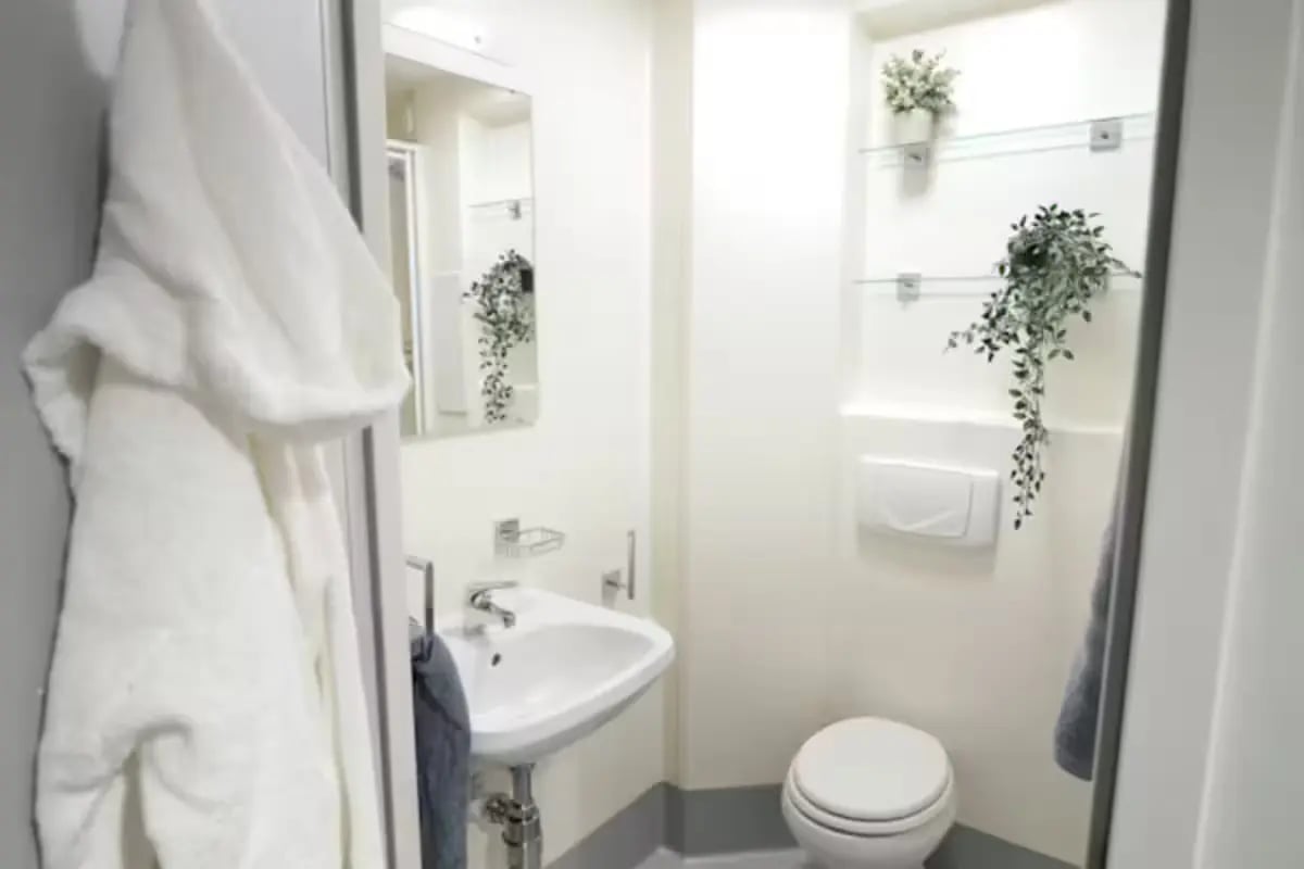 White robe sink toilet plants bathroom at Portsburgh Court in Edinburgh Student Accommodation