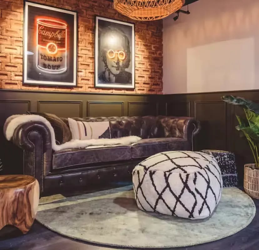 Chesterfield sofa with artwork and pouf living room at Portsburgh Court in Edinburgh Student Accommodation