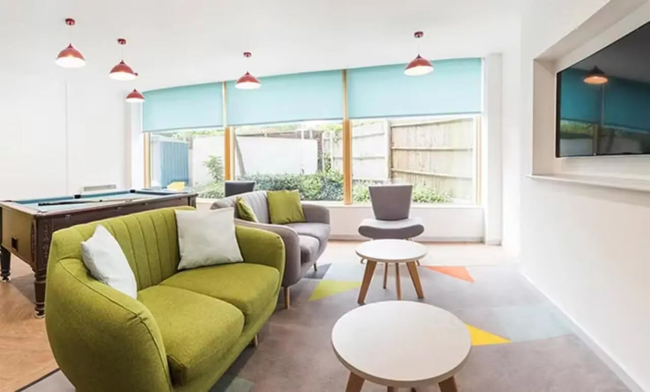 Pool table sofas coffee tables living room at Charles Morton Court in London Student Accommodation