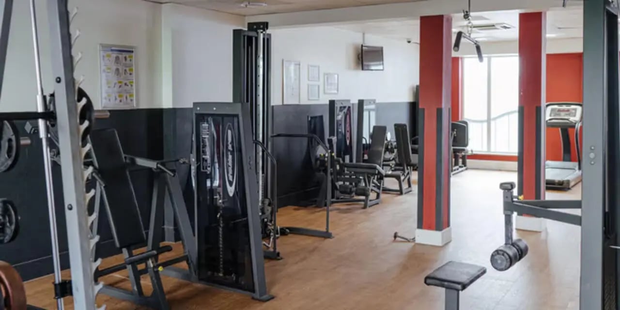 Gym equipment including weight machines and treadmill fitness area at The Heights in Birmingham Student Accommodation