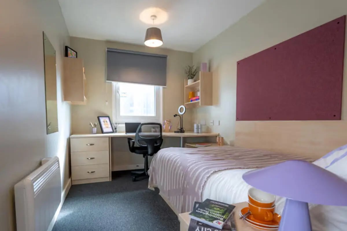 Bed desk chair window and heater bedroom at The Heights in Birmingham Student Accommodation