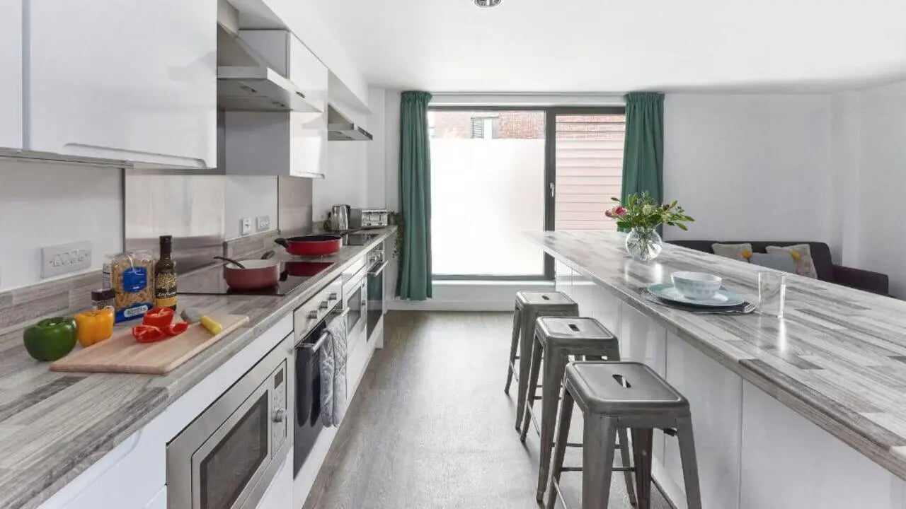 Modern kitchen with island and bar stools kitchen at Selly Oak Apartments in Birmingham Student Accommodation