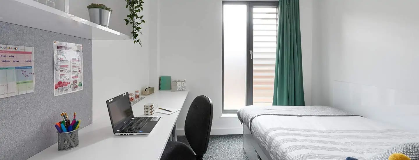 Bed desk with laptop and chair bedroom at Selly Oak Apartments in Birmingham Student Accommodation