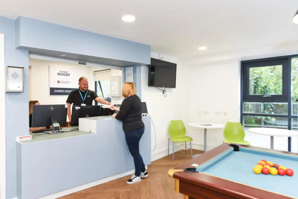 Reception desk with computers and pool table common area at Newcastle 1 in Newcastle Upon Tyne Student Accommodation