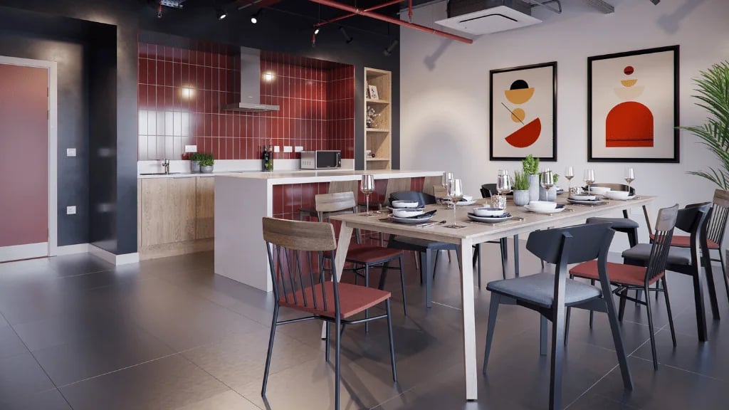 Dining table with place settings kitchen island pantry and art at Exchange Court in Leeds Student Accommodation