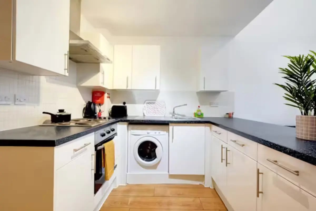 Stove washing machine sink white cabinets kitchen at Newarke Street Leicester in Leicester Student Accommodation