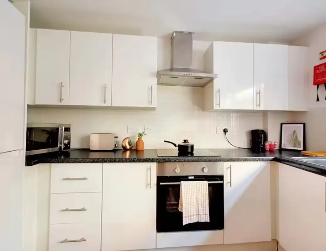 White cabinets microwave oven toaster kettle kitchen at Newarke Street Leicester in Leicester Student Accommodation