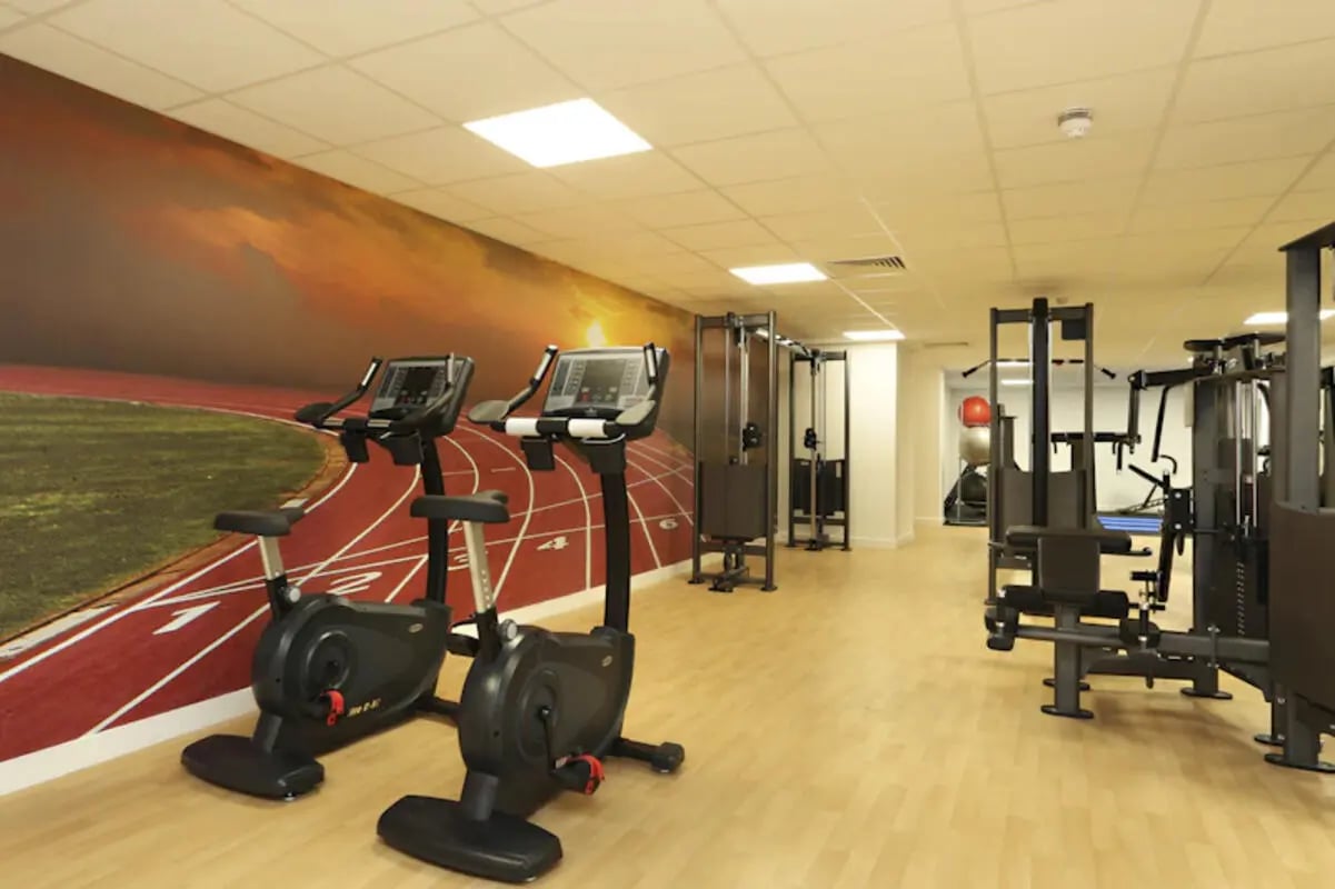 Two exercise bikes and weight machines gym at Keele House in Newcastle Under Lyme Student Accommodation