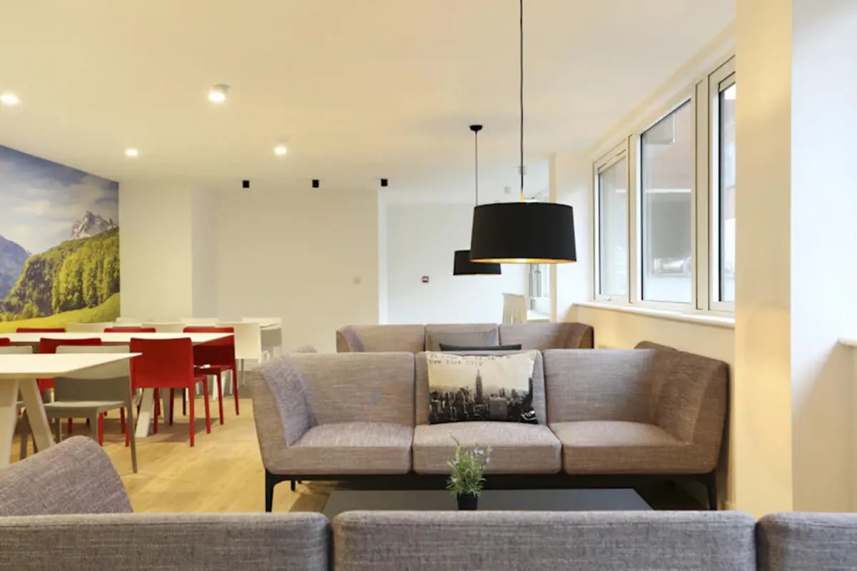 Sofa tables chairs mountain mural living room at Keele House in Newcastle Under Lyme Student Accommodation