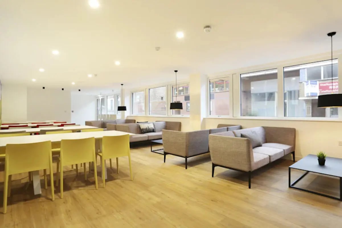 Sofa tables chairs and yellow chairs lounge at Keele House in Newcastle Under Lyme Student Accommodation