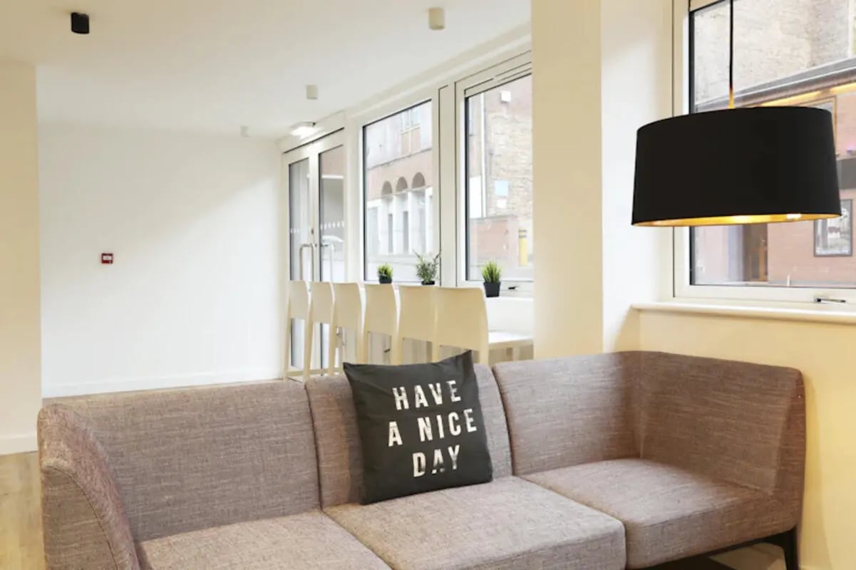Sofa with patterned pillow and pendant lamp Living room at Keele House in Newcastle Under Lyme Student Accommodation