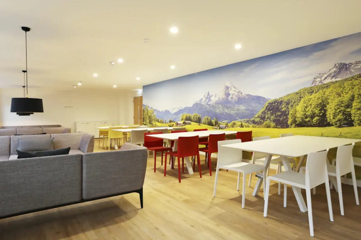 Seating area with tables and chairs communal room at Keele House in Newcastle Under Lyme Student Accommodation