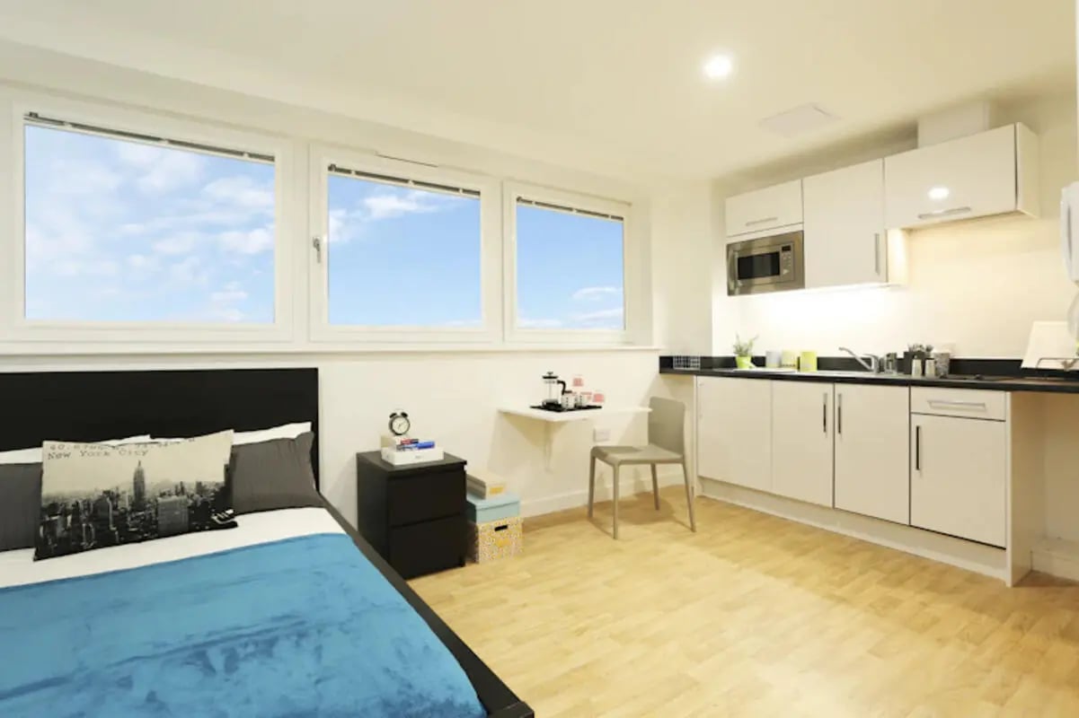 Bed nightstand desk chair kitchen area studio at Keele House in Newcastle Under Lyme Student Accommodation