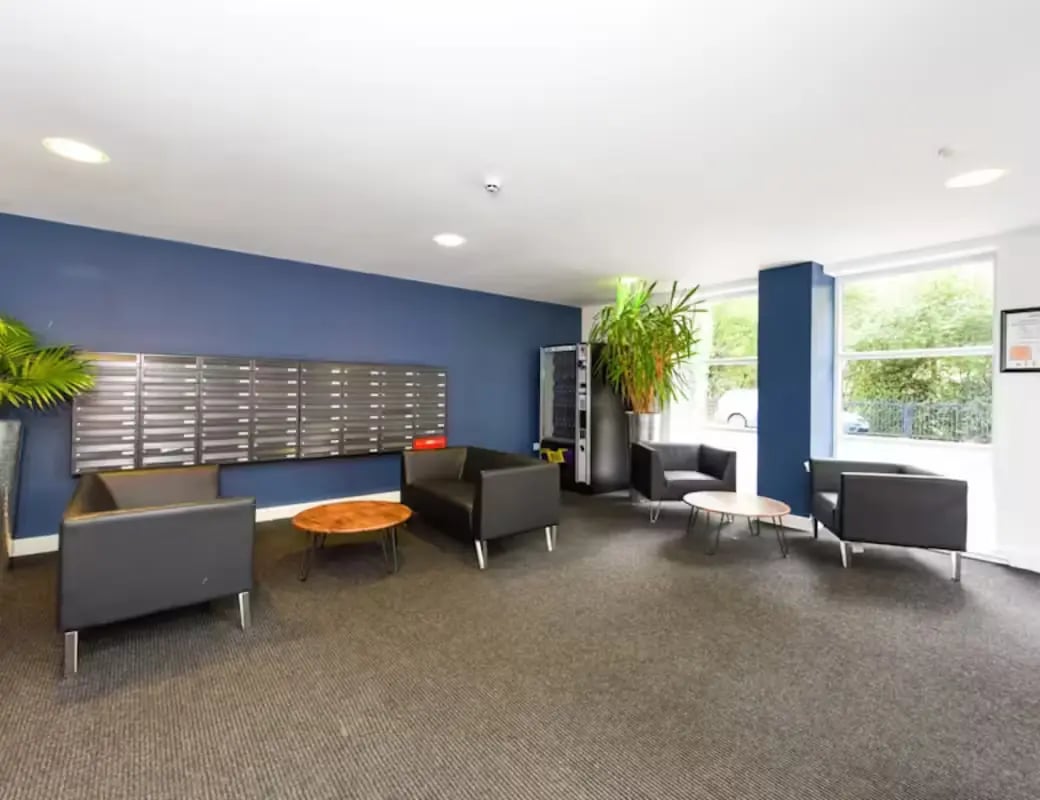Lounge area with sofas mailboxes and plants communal area at The Summit Leicester in Leicester Student Accommodation
