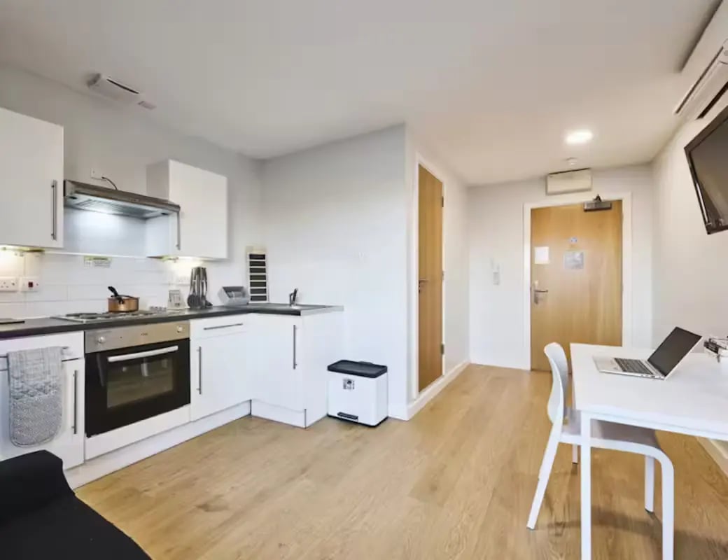 Modern white kitchen with laptop desk kitchen area at The Summit Leicester in Leicester Student Accommodation