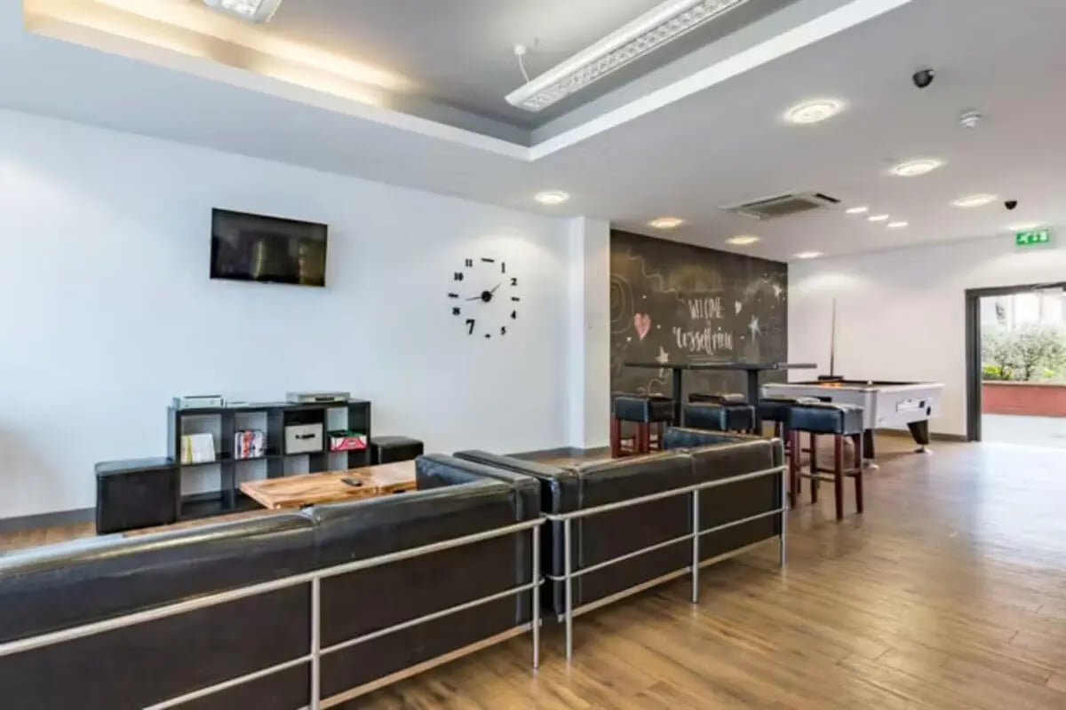 Sofa TV shelf clock pool table common area at Russell View in Nottingham Student Accommodation