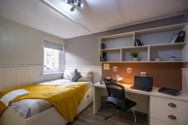 Bed desk shelves and laptop bedroom interior at Meadow Court in Edinburgh Student Accommodation