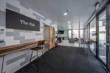 Modern lounge area with seating and tables common area at Meadow Court in Edinburgh Student Accommodation