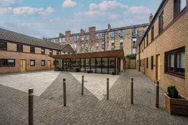 Courtyard with modern building and surrounding apartments exterior at Meadow Court in Edinburgh Student Accommodation