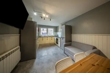 Modern kitchen living area with sofa and table kitchen living area at Meadow Court in Edinburgh Student Accommodation