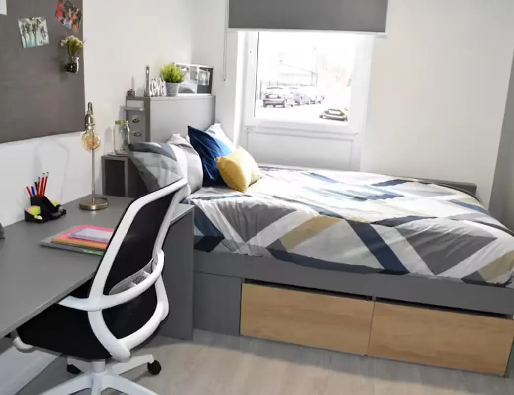 Bed desk chair and photos bedroom at Queens Court Leicester in Leicester Student Accommodation