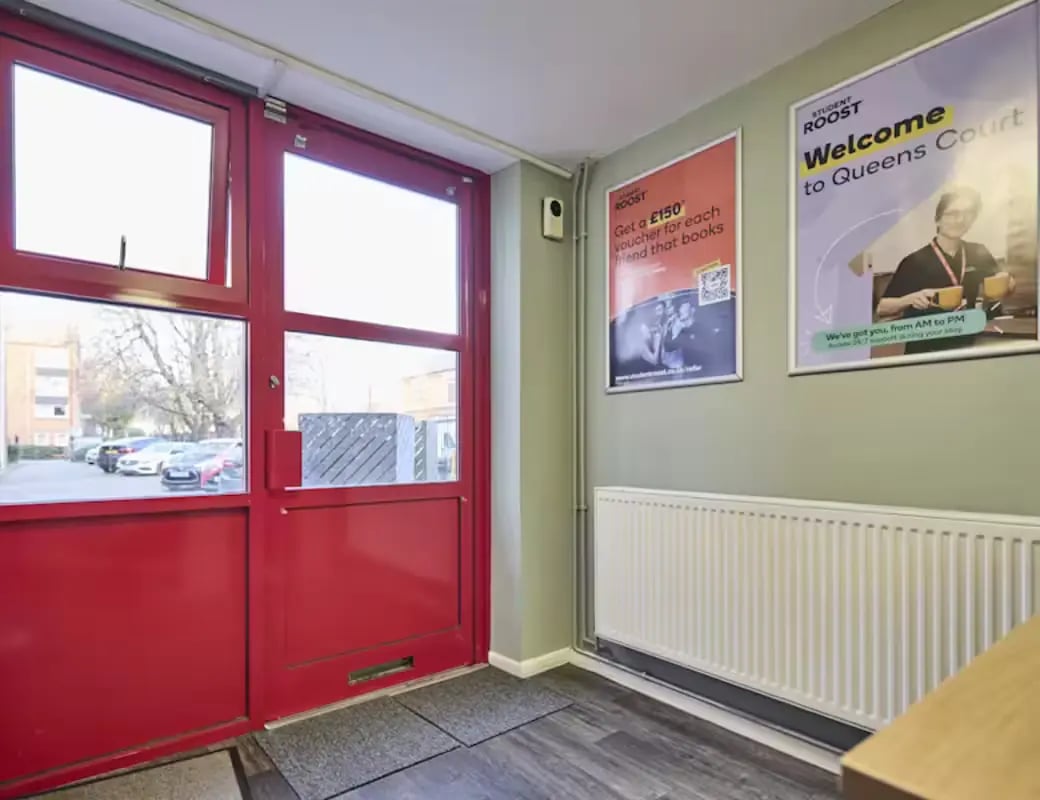 Red double doors posters and radiator entrance area at Queens Court Leicester in Leicester Student Accommodation