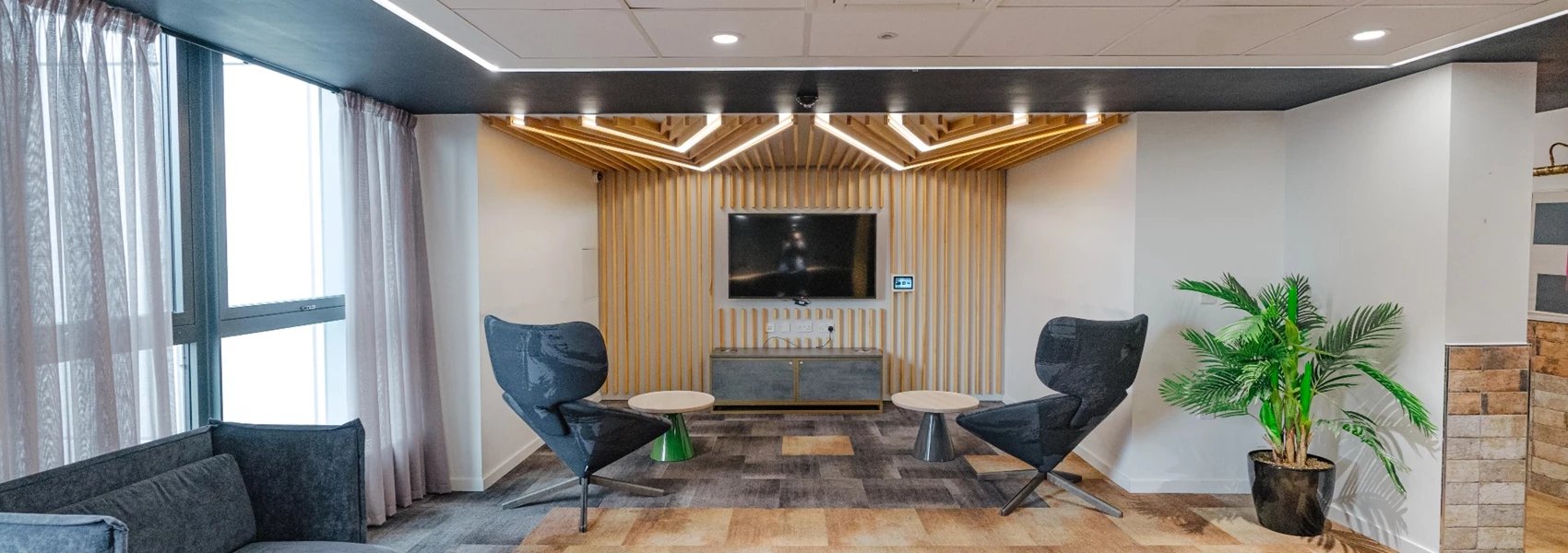 Two chairs TV media console plant living room at Chapter Ealing in London Student Accommodation