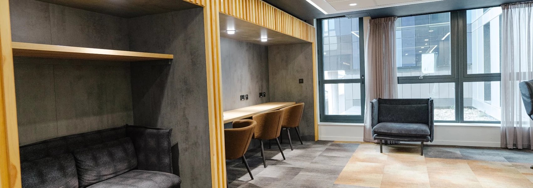 Sofa booth desk chairs lounge area living room at Chapter Ealing in London Student Accommodation