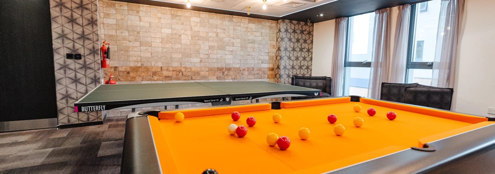 Pool table ping pong table and seating area recreation area at Chapter Ealing in London Student Accommodation