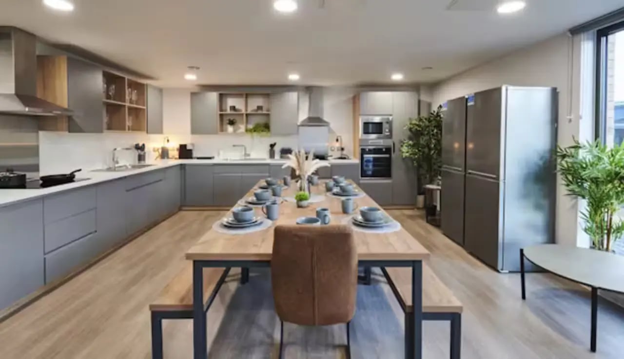 Kitchen with long dining table and seating kitchen Image at York House in Nottingham Student Accommodation