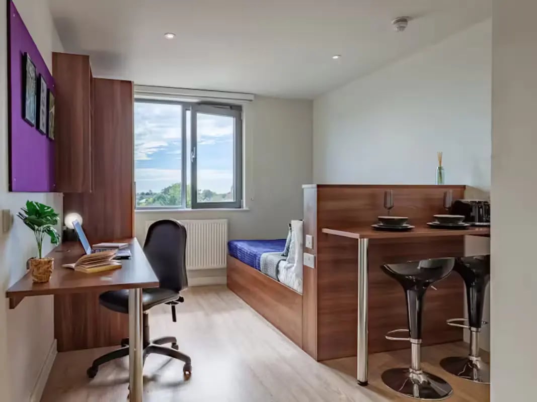 Desk chair laptop bed and bar stools studio apartment at Central Studios - London in London Student Accommodation