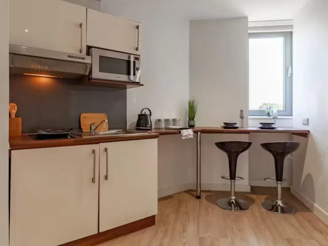 Modern kitchen with breakfast bar and stools kitchen at Central Studios - London in London Student Accommodation