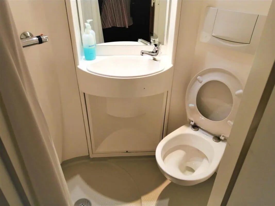 Toilet sink and shower curtain bathroom at Longside House Bradford in Bradford Student Accommodation