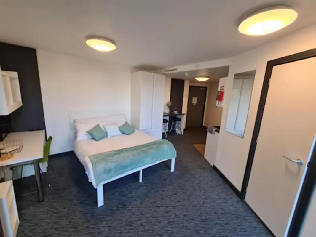 Bed desk wardrobe and small kitchen area bedroom at St James Point in Newcastle Upon Tyne Student Accommodation