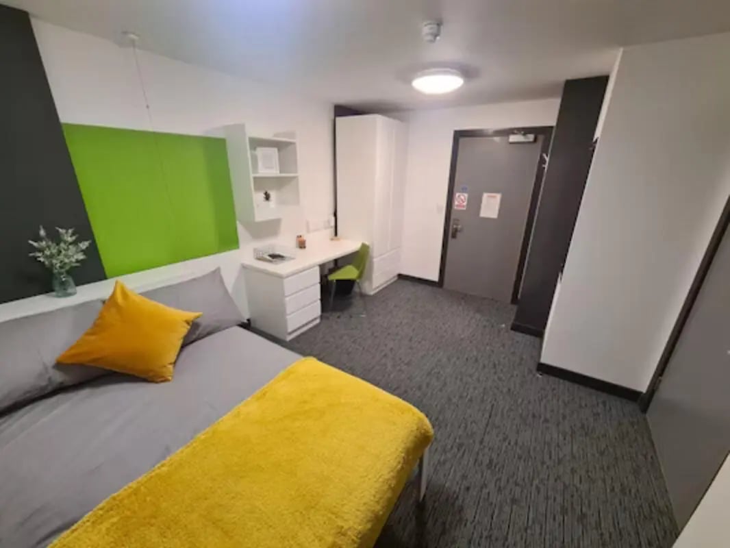 Bed desk wardrobe and door bedroom at St James Point in Newcastle Upon Tyne Student Accommodation