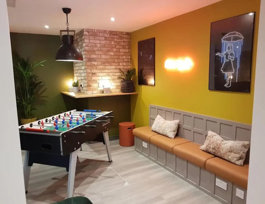Foosball table lounge bench neon art living area at St James Point in Newcastle Upon Tyne Student Accommodation