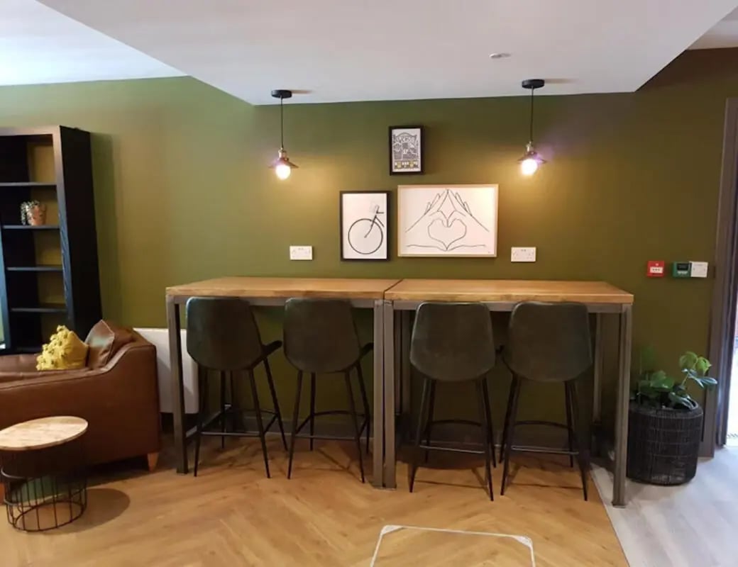 High table with bar stools and sofa living area at St James Point in Newcastle Upon Tyne Student Accommodation