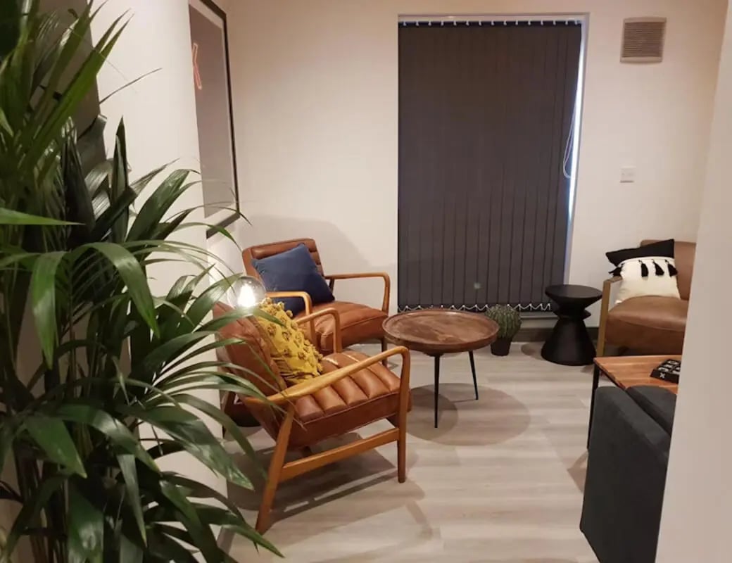 Two leather chairs coffee table living room at St James Point in Newcastle Upon Tyne Student Accommodation