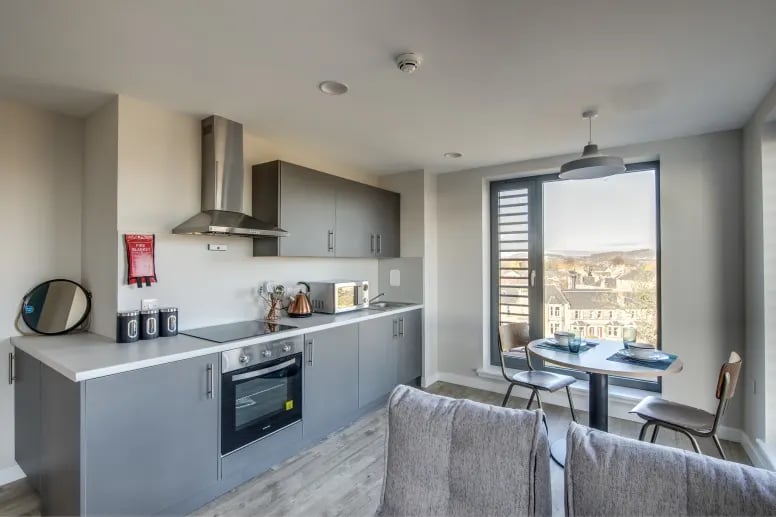 Modern grey kitchen with dining table and window kitchen at Riverside Quay in Stirling Student Accommodation