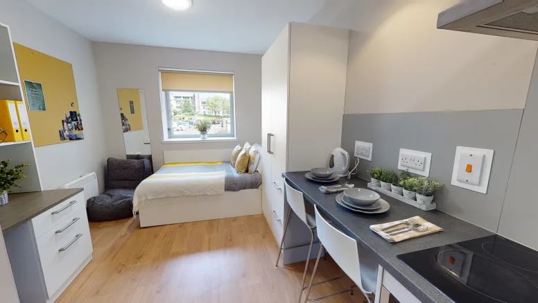 Bed desk and kitchen area student studio at Centro House in Stirling Student Accommodation