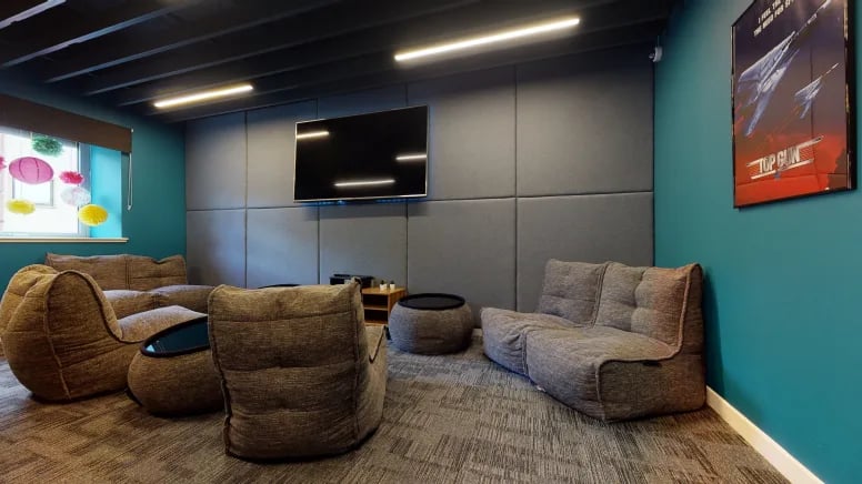 Beanbags TV movie poster and teal wall Living room at Centro House in Stirling Student Accommodation